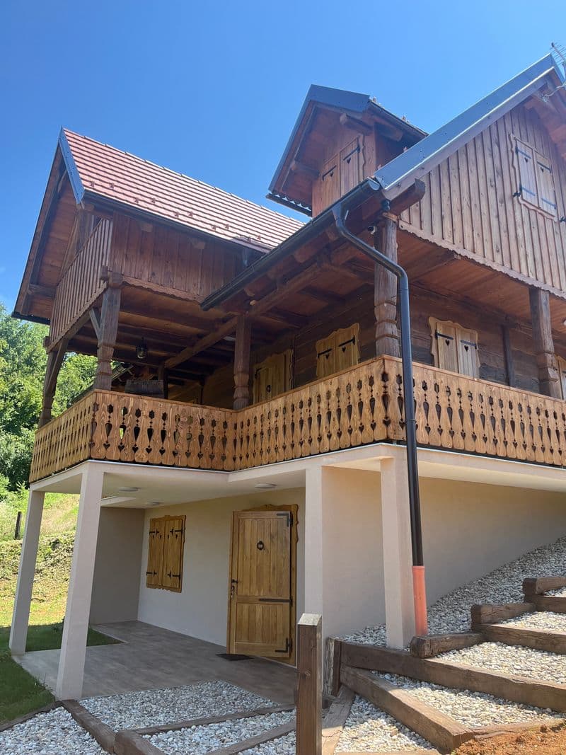 Hand-carved wooden balcony and shutters on the oak house facade