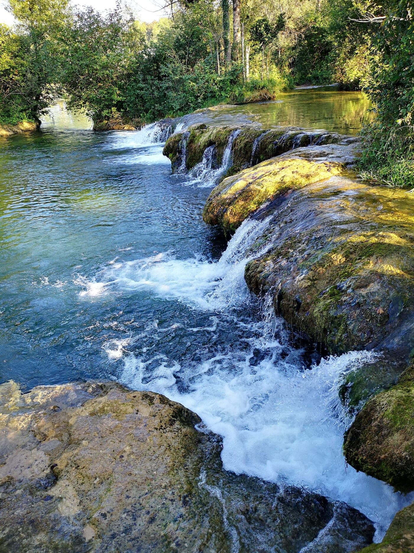 Cascading travertine waterfalls on the crystal-clear Mrežnica river